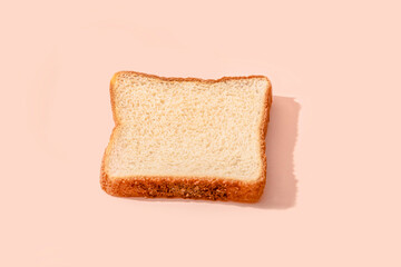 Slice of bread over peach background