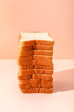 Stack of bread slices over peach background