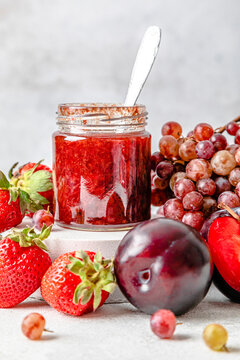 Homemade strawberry jam with various fruits kept on table