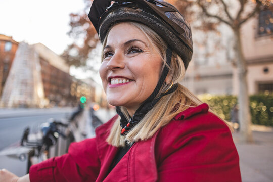 Cheerful Mature Woman Riding Bicycle Helmet