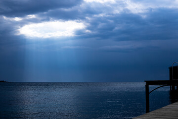 Sun rays breaking from clouds over the sea