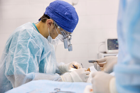 Surgeons performing eye surgery on patient at clinic
