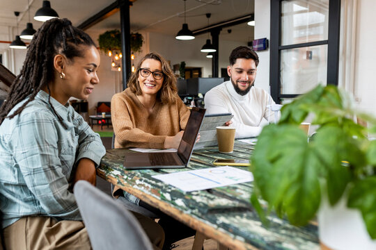 Businesswoman sitting with colleagues in office