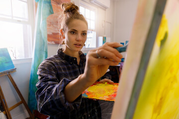 Portrait of Female Artist Works on Abstract Oil Painting, Moving Paint Brush Energetically She Creates Modern Masterpiece.