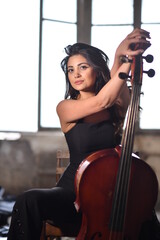 the beautiful girl in the black jumpsuit with the cello in the ruined area © Lilit