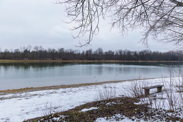 View over Kuhsee lake with seagulls ducks and swans near Augsburg on a cold gray winter day
