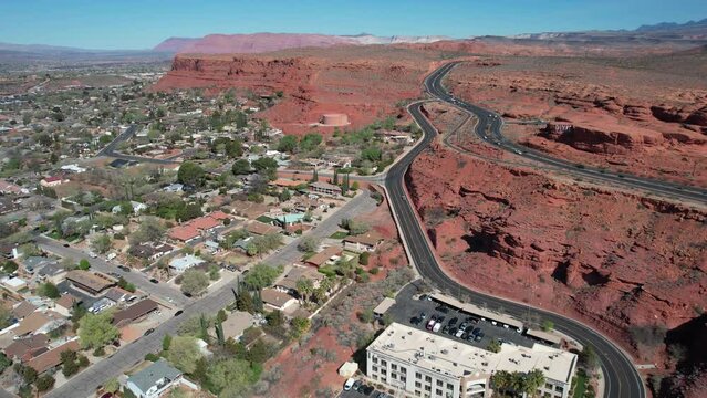St. George, Utah USA. Traffic on Red Hills Above Cityscape, Drone Shot