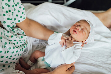 Infant sleeping in arms of mother