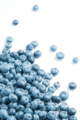 Fresh blueberries scattered on a white background.
