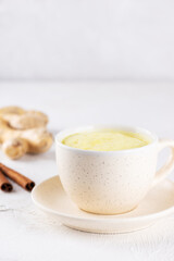 Golden milk with almond milk, ginger, turmeric and cinnamon in a mug, sugar and lactose free.