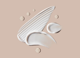 cosmetic smears of creamy texture on a beige background