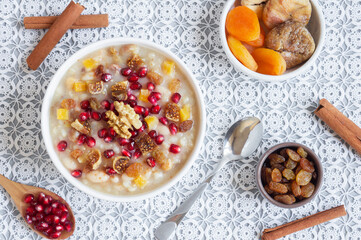 Traditional Turkish delicious mixed dessert, ashura (asure) with pomegranate seeds, walnut, apricot, Noah’s pudding