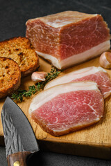 Closeup salted pork belly joint meat on wooden cutting board