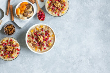 Traditional Turkish delicious mixed dessert, ashura (asure) with pomegranate seeds, walnut,...