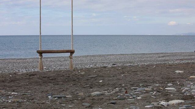 Swing movement on the beach near the sea