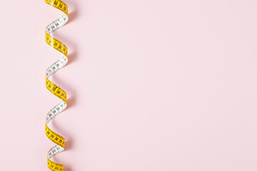 Tape Measure on Pink Background