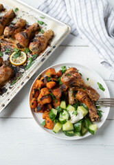 Light dinner or lunch with oven baked chicken drumsticks, roasted sweet potatoes and cucumber salad