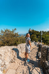Young beautiful woman smiles against the backdrop of the Guaita Fortress, San Marino, Italy
