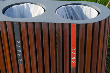 Public trash cans for separation waste, sections of cans and paper closeup