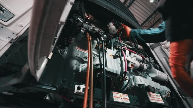 With steady hands and expert precision, the skilled mechanic expertly untights a stubborn bolt, making sure to keep the surrounding machinery safe and secure.