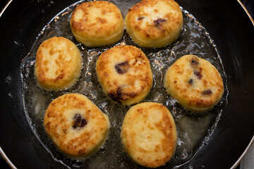 fresh tasty cheese pancakes cheesecakes are fried in a pan, ukraine traditional food