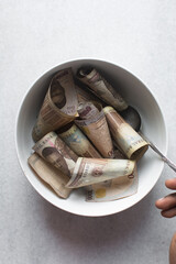 Eating money with spoon, eating Nigerian 1000 Naira notes with spoon
