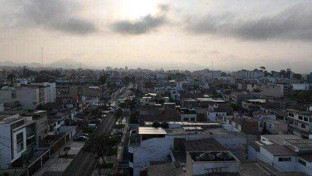 Drone Flying Down Between Buildings In Lima Residential Area, Peru 