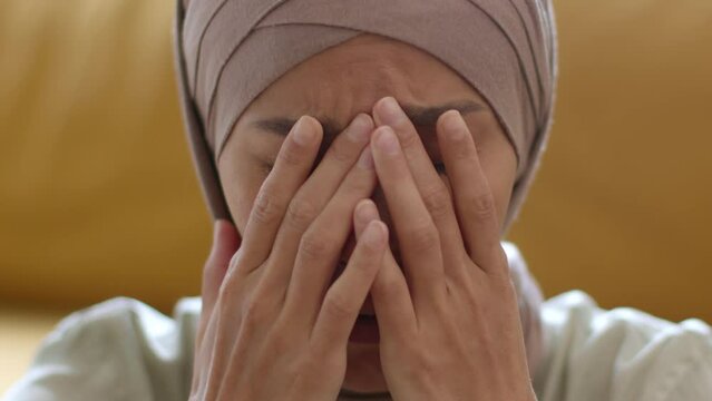 Close up portrait of nervous unhappy muslim woman wearing traditional lady crying, feeling depressed