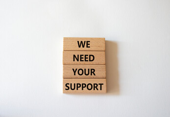 We need your support symbol. Wooden blocks with words We need your support. Beautiful white background. Business and We need your support concept. Copy space.