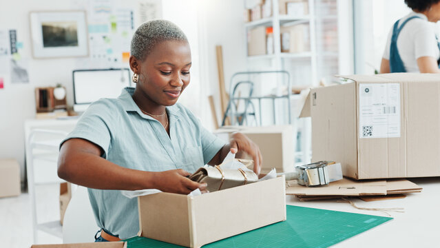 Startup, shop and entrepreneur packing a box for an order of products for shipment or delivery. Black business owner preparing a retail package for courier with her corporate partner in their office.