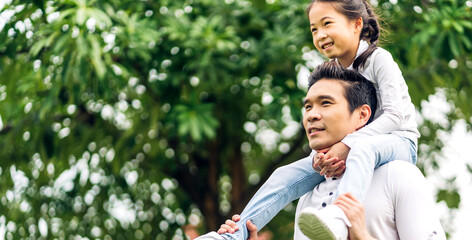 Portrait of enjoy happy love asian family father and mother holding hug cute little asian girl child smiling play and having fun moments good time in summer park at home.