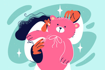 Smiling girl with teddy bear in hands