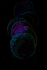 Illustration of colorful candies, fantasy iridescent colors, explosion of colors. Abstract artwork with dark background.