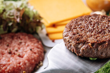 barbecue burger cutlet. barbeque concept in nature. barbecue spatula with a burger patty on it