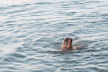 Fototapeta premium girl on vacation in the sea. The concept of Spa, swimming lessons, vacations, water treatment.