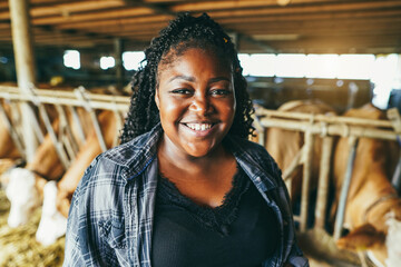 Portrait of young african farmer woman working inside cowshed - Focus on face © DisobeyArt
