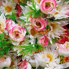 Pale pink and white artificial handmade roses and chrysanthemums bunch, floral background.