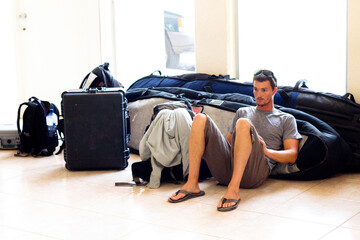 A man waits for his flight at the Manzanillo International Airport in Manzanillo, Mexico on May 7, 2011.  He was feeling sick and weary after surfing at Pascuales for several days 
