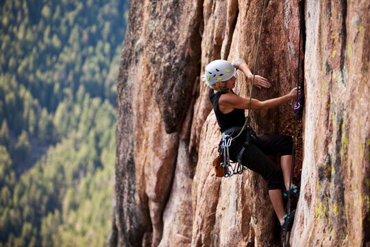 A athletic woman rock climbing near Bozeman, Montana. - Powered by Adobe