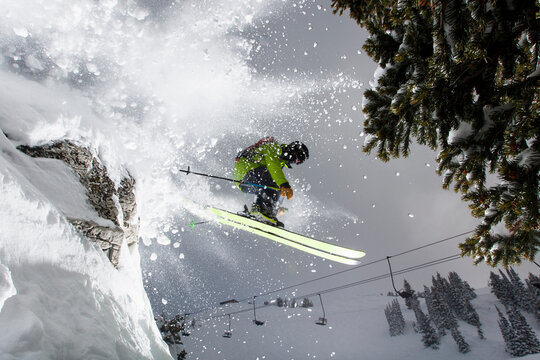 Extreme skier jumping off cliff