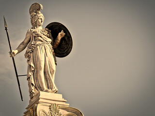 Athena, the ancient warrior goddess of knowledge and science, a marble statue on an Ionian rhythm column. Travel to Athens, Greece.