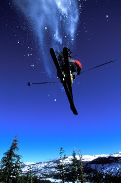 Man jumping off a cliff on skis.