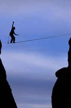 A man balances on a slack line.