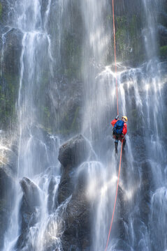 Man Canyoning down a waterfall in the Cascade Mountains, Washington State