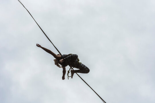 View from below of woman slacklining, Dibs Quarry, Maripora, Sao Paulo State, Brazil