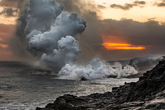 Steam rises when Lava from Kilauea Volcano pours into ocean at Kamokuna