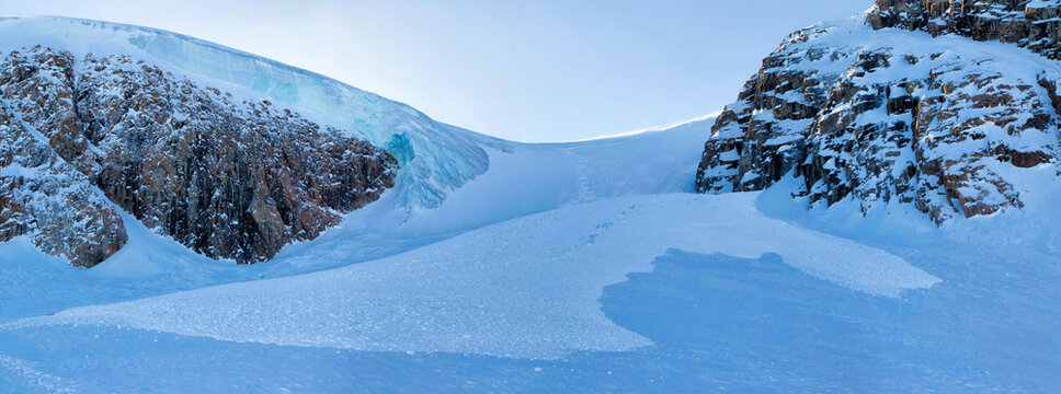A massive avalanche triggered by a mountaineering team attempting a first ascent up an unnamed glacier, in the Stauning Alps of Greenland.