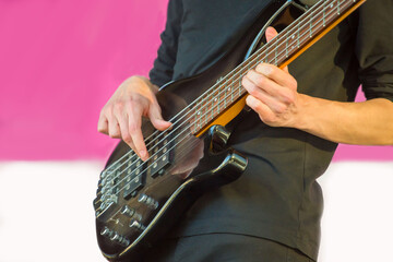 a musician plays an electric guitar on a city street.