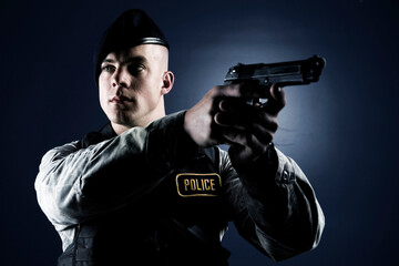 A Caucasian, male, Air Force Security Forces Airman in uniform poses with his M-9 pistol.