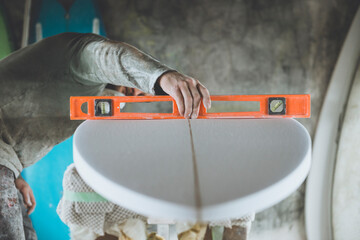 Surfboard Shaper refining a new design